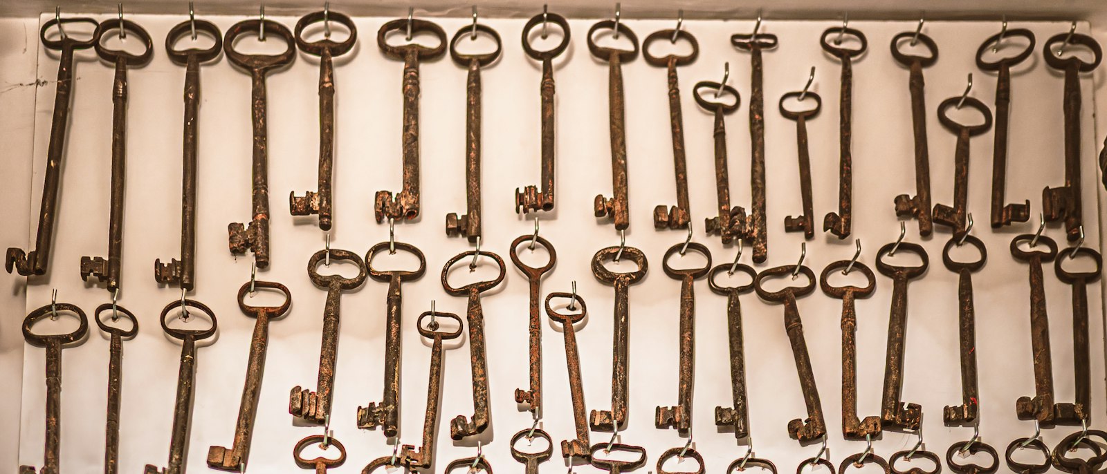 Many old keys hanging on a wall